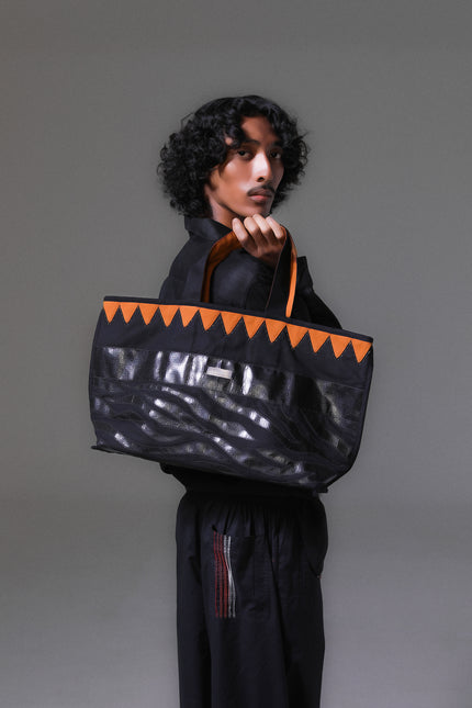 Mascha Tote Bag made from durable canvas with contrast lining, featuring triangle appliqué, hand-stitch details, and a zebra-patterned motif in repurposed Terpal, designed with an internal pomet for everyday use.