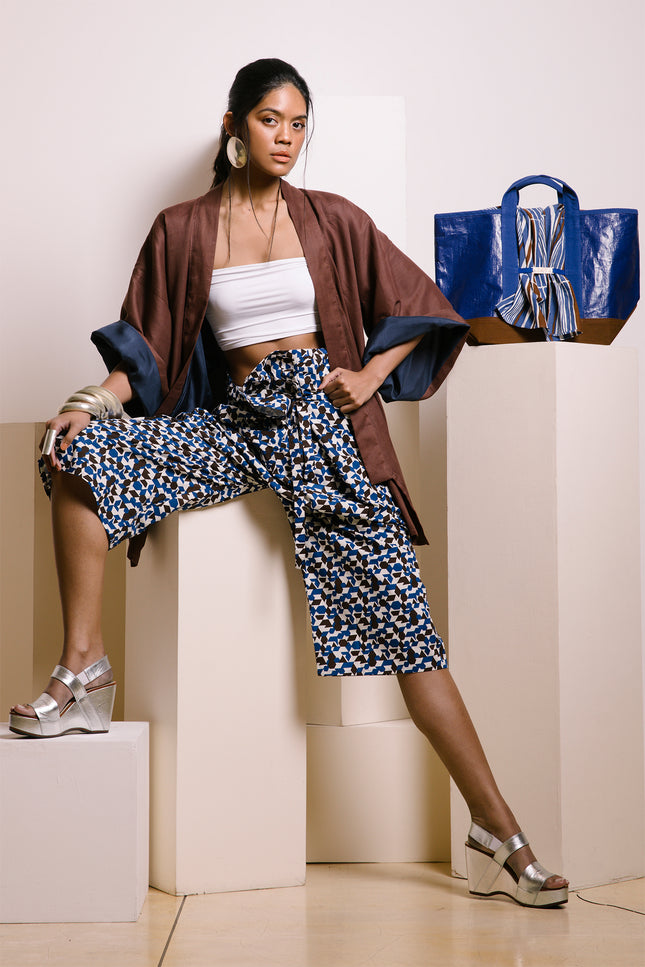 Model wearing Fran Thai Pants in pure cotton, with a handmade yarn-dyed, block-printed pattern, a relaxed unisex silhouette, a non-detachable waist belt decoration, and a single side square pocket for a crafted, comfortable look.