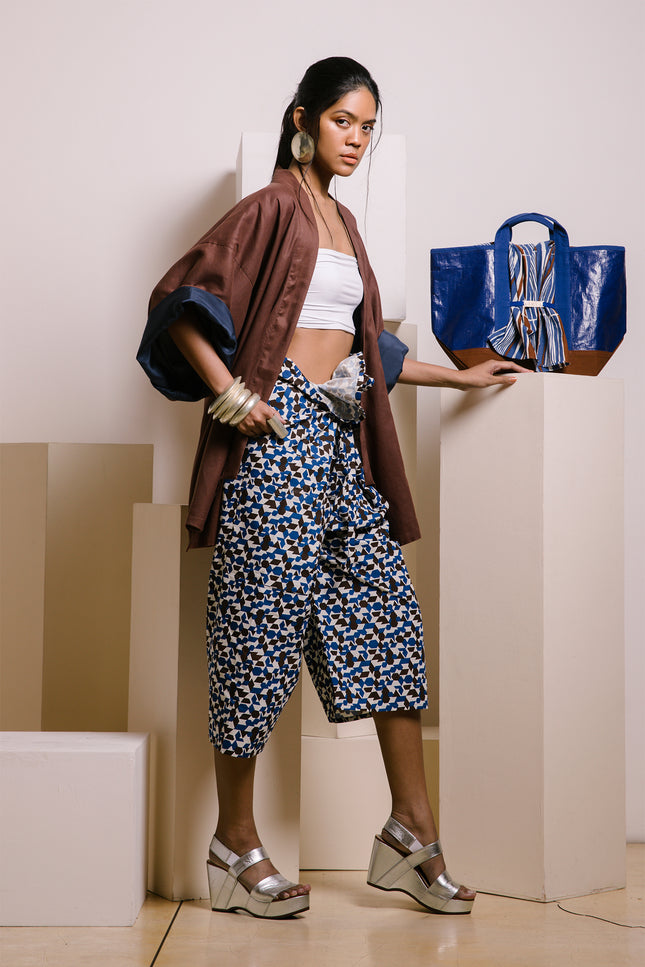 Model wearing Fran Thai Pants in pure cotton, with a handmade yarn-dyed, block-printed pattern, a relaxed unisex silhouette, a non-detachable waist belt decoration, and a single side square pocket for a crafted, comfortable look.