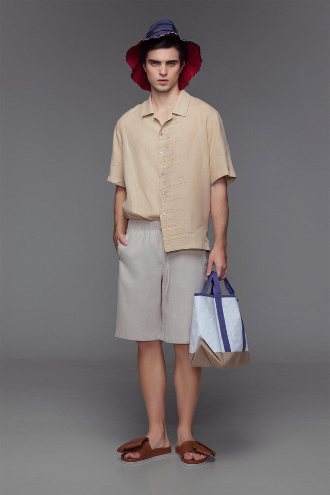 Model wearing Lugh Shorts in pure linen with elastic waistband and adjustable drawstrings that are effortlessly comfortable and timeless for resort or summer wear.