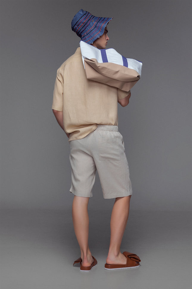 Model wearing Lugh Shorts in pure linen with elastic waistband and adjustable drawstrings that are effortlessly comfortable and timeless for resort or summer wear.