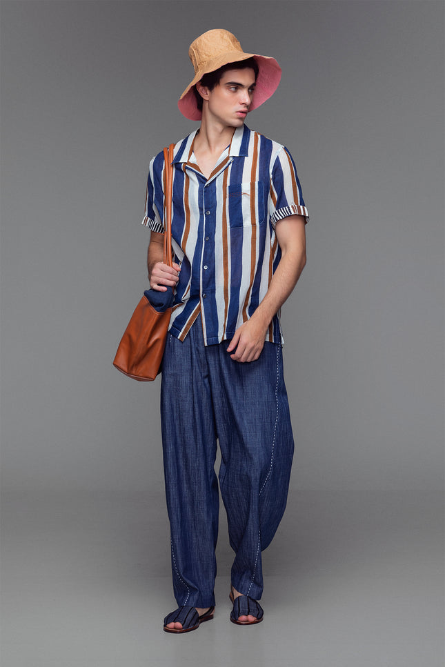 Model wearing cotton camp shirt with handmade block print, contrast sleeves, and notch collar.
