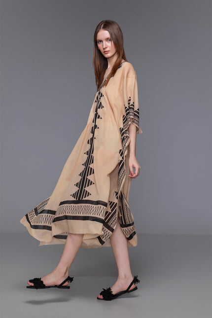 Model wears Najae Kaftan with deep V-neck, pintuck details, and block-printed motifs in sheer cotton.
