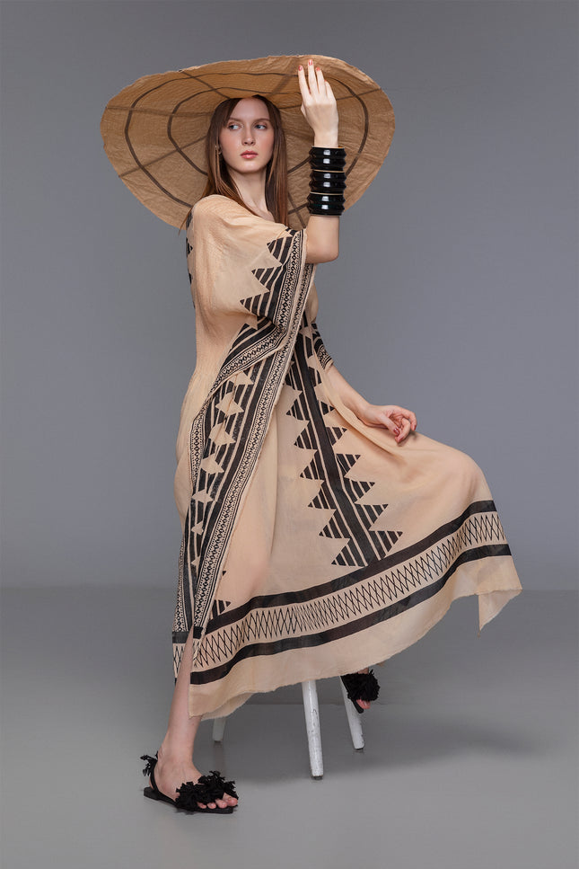 Model wears Najae Kaftan with deep V-neck, pintuck details, and block-printed motifs in sheer cotton.