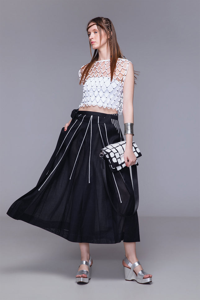 Model wearing Malakhi Pants with voluminous unisex silhouette, lightweight cotton-ramie fabric, non-detachable waist belt, and contrast ribbon detailing for a confident, contemporary look.