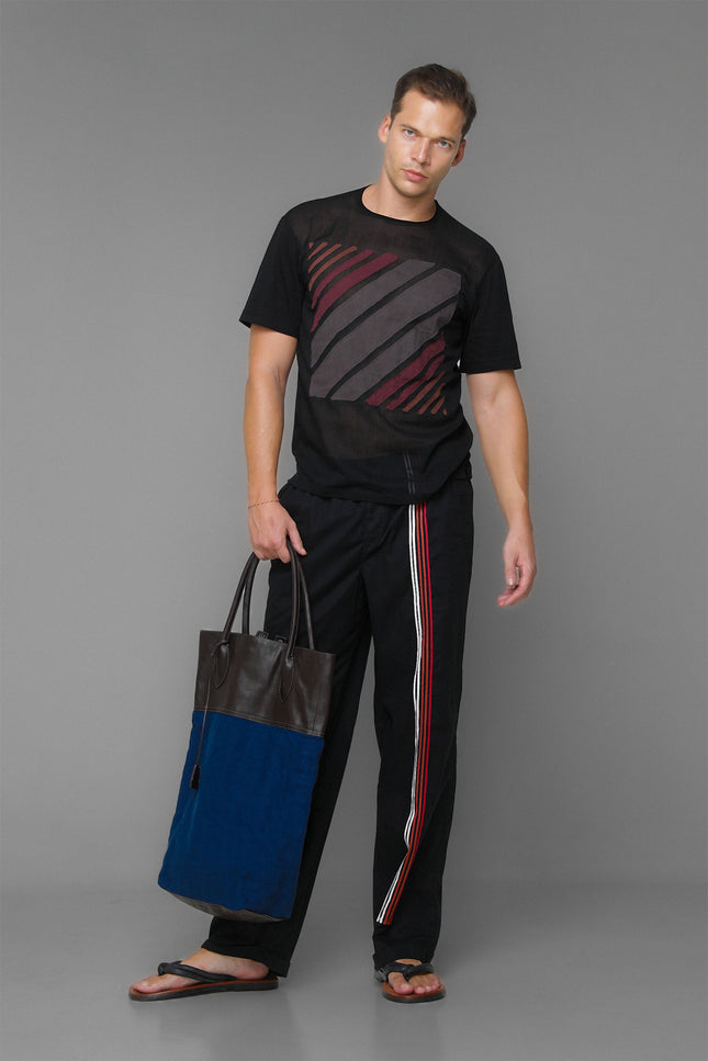 Model wearing Black Marko T-Shirt with short sleeves, round neckline, square striped applique, and contrast fabric details.