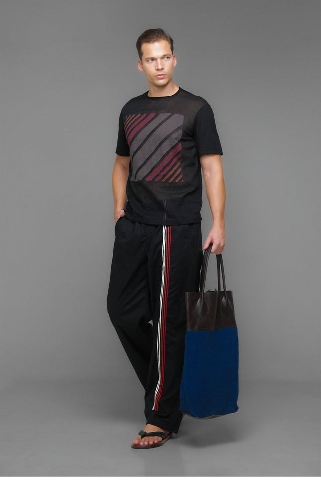 Model wearing Black Marko T-Shirt with short sleeves, round neckline, square striped applique, and contrast fabric details.