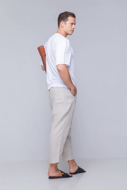 Model wearing the oversized Naman T-Shirt in pure cotton with a round neckline, invisible henley plamet, rolled applique, and dual-fabric contrast, designed for breathable comfort and modern style.