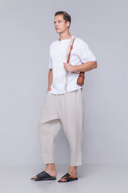 Model wearing the oversized Naman T-Shirt in pure cotton with a round neckline, invisible henley plamet, rolled applique, and dual-fabric contrast, designed for breathable comfort and modern style.
