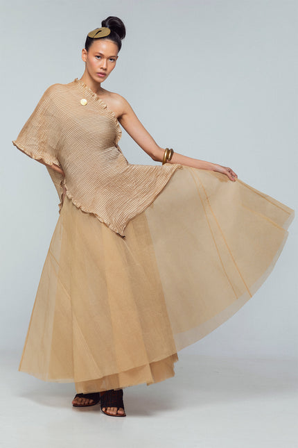 Model wearing a silk satin scarf with pintuck detailing, styled as a flowing layered piece with adjustable straps.