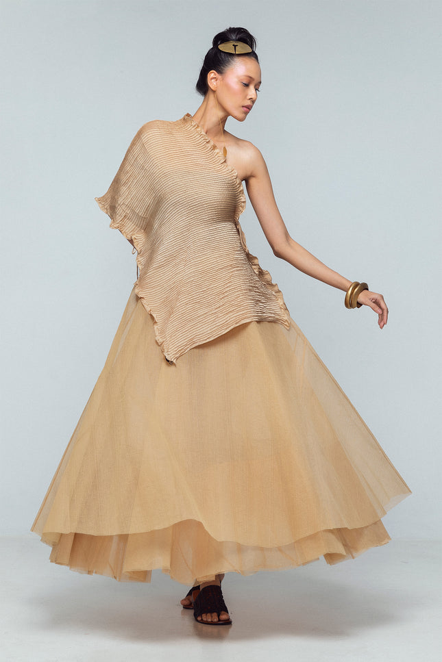 Model wearing a silk satin scarf with pintuck detailing, styled as a flowing layered piece with adjustable straps.