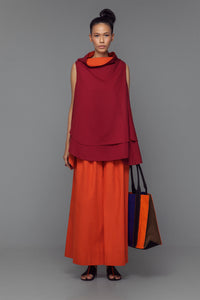 Model wearing cotton mini dress with cowl neck, shown in a color block option of tango orange and bordeaux.