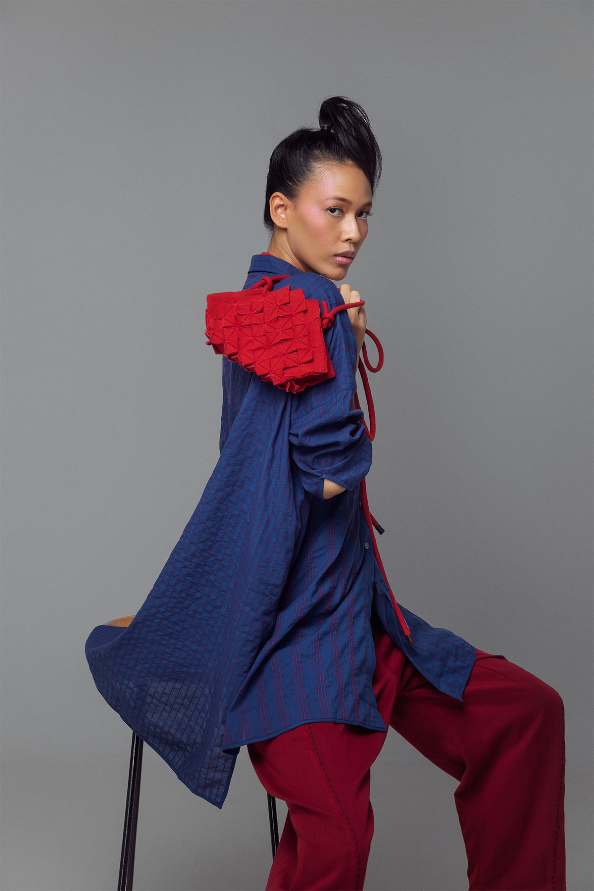Model wearing oversized long-sleeve shirt dress with full vertical buttons, styled as a casual yet polished tunic.