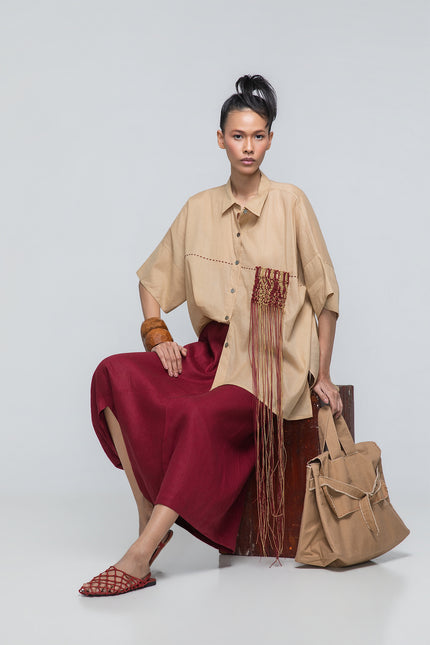 Model wearing Natsuko Shirt with an oversized boxy silhouette, dropped shoulders, macramé cord detailing, and hand-stitched decoration.