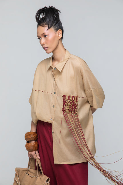Model wearing Natsuko Shirt with an oversized boxy silhouette, dropped shoulders, macramé cord detailing, and hand-stitched decoration.