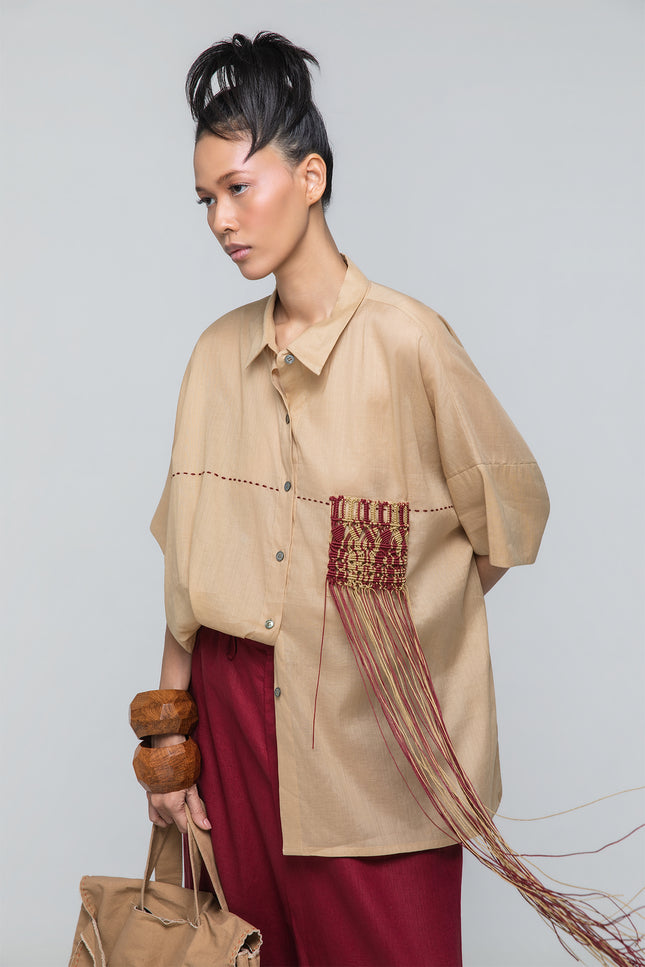 Model wearing Natsuko Shirt with an oversized boxy silhouette, dropped shoulders, macramé cord detailing, and hand-stitched decoration.