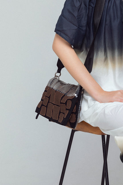 Liebe Clutch made from cotton with contrast croco appliqué and sequin embellishments, featuring a foldable design with detachable strap, zip closure, and inner patch pomet for versatile styling.