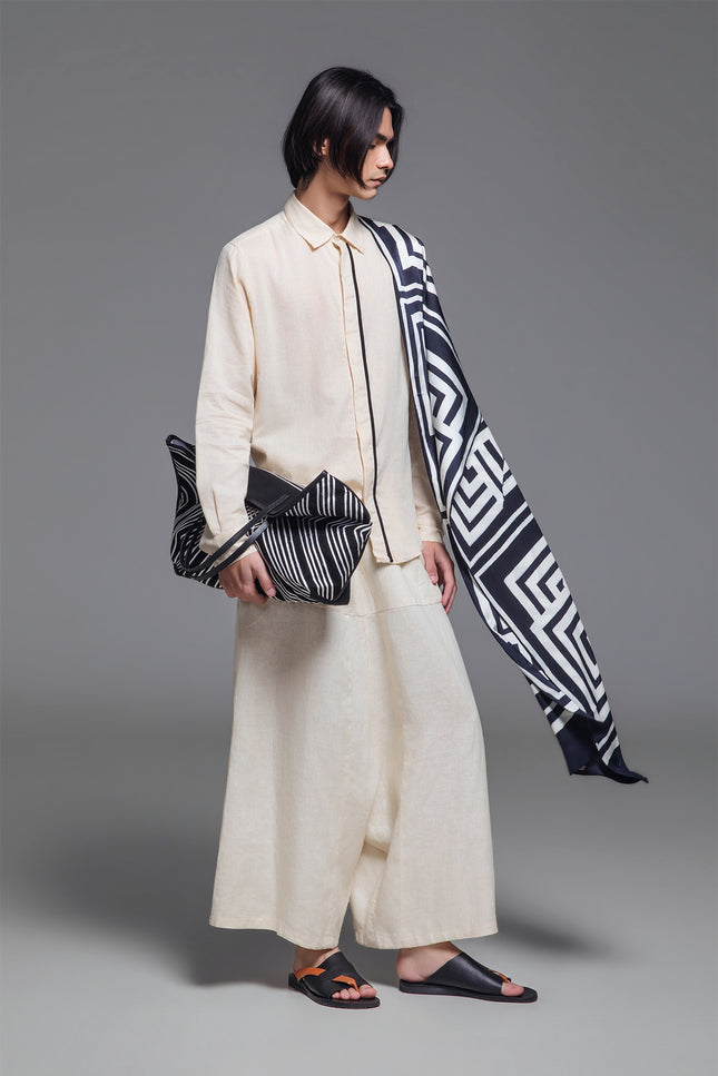Model wearing Orlee Shirt in double-layered cotton, featuring a relaxed silhouette, U-shaped hemline, hidden button placket, and contrast piping details.