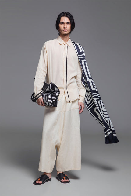 Model wearing Orlee Shirt in double-layered cotton, featuring a relaxed silhouette, U-shaped hemline, hidden button placket, and contrast piping details.