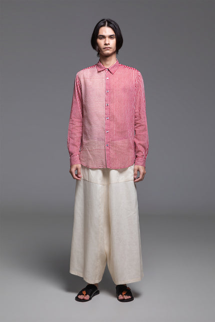 Model wearing Osmont Shirt in pure cotton, featuring a regular-fit silhouette, collared neckline, structured cuffs, and mixed-orientation block print.