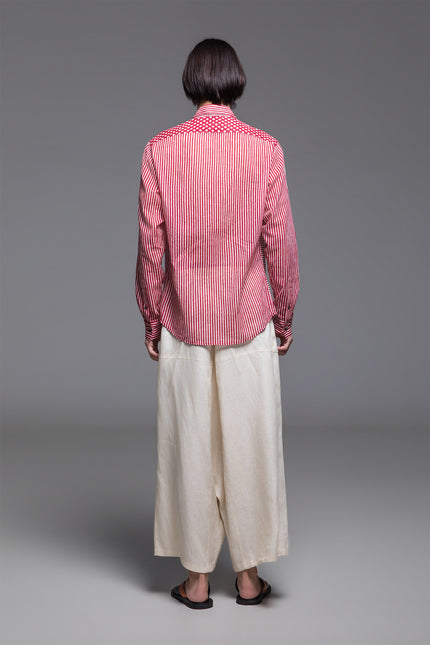 Model wearing Osmont Shirt in pure cotton, featuring a regular-fit silhouette, collared neckline, structured cuffs, and mixed-orientation block print.