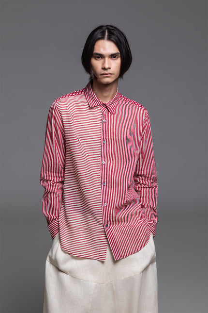 Model wearing Osmont Shirt in pure cotton, featuring a regular-fit silhouette, collared neckline, structured cuffs, and mixed-orientation block print.
