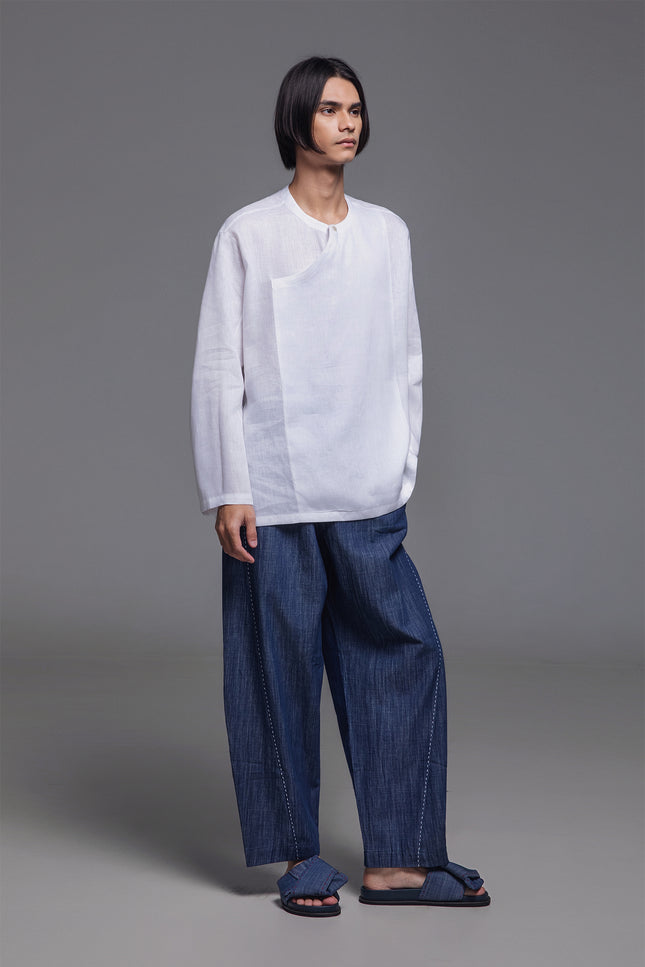 Model wearing Noel Pants with curved balloon-leg  silhouette, elastic drawstring waist, tapered ankle, and subtle hand-stitched detailing.