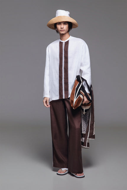 Model wearing Otmar Koko Shirt in breathable linen, featuring a relaxed straight silhouette, band collar, button closure, and contrasting front stripe panel.