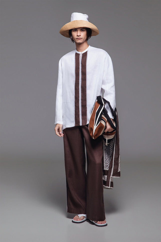 Model wearing Otmar Koko Shirt in breathable linen, featuring a relaxed straight silhouette, band collar, button closure, and contrasting front stripe panel.