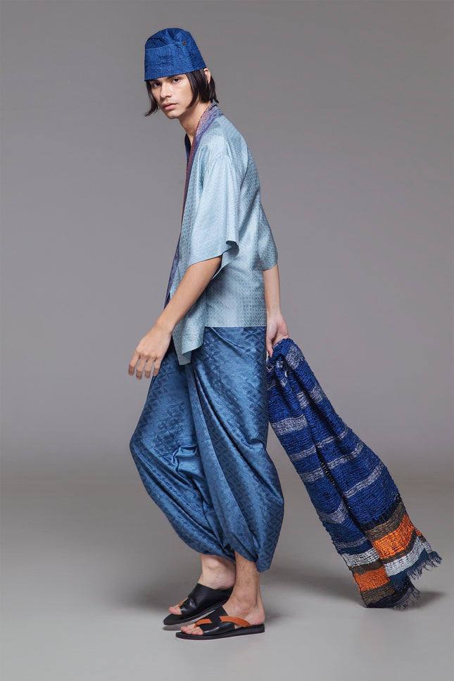 Model wearing Natsu Kimono in jacquard silk, featuring a relaxed silhouette, wide mid-length sleeves, and a structured collar with subtle textured finish.