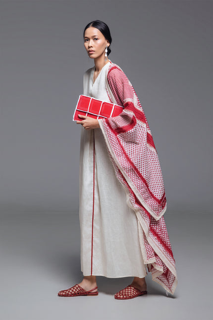 Model wearing the Ondrey Scarf in 100% cotton, featuring assorted handmade block-print patterns and double-color fringe stripes along the center and edges.