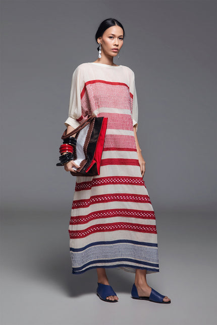 Model wearing Onida Kaftan in lightweight cotton, featuring a loose full-length silhouette with horizontal block print appliqué in Indian red and blue.