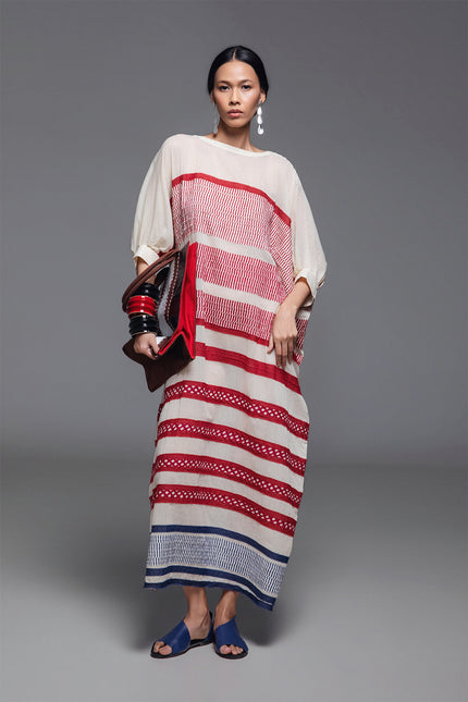 Model wearing Onida Kaftan in lightweight cotton, featuring a loose full-length silhouette with horizontal block print appliqué in Indian red and blue.