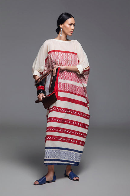 Model wearing Onida Kaftan in lightweight cotton, featuring a loose full-length silhouette with horizontal block print appliqué in Indian red and blue.