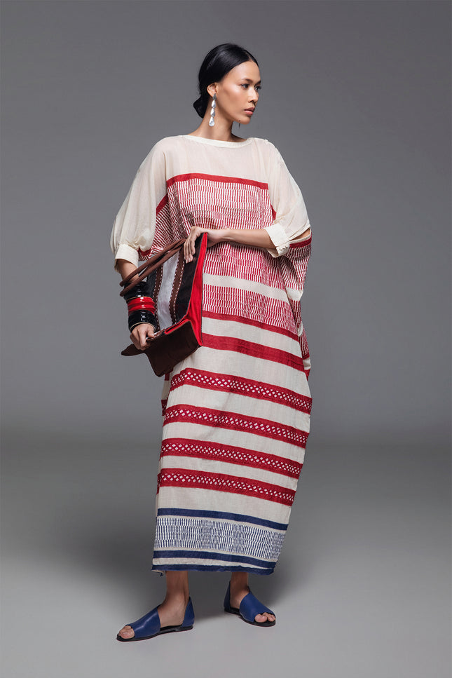 Model wearing Onida Kaftan in lightweight cotton, featuring a loose full-length silhouette with horizontal block print appliqué in Indian red and blue.