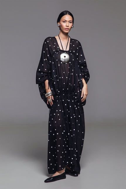 Model wearing Olivine Kaftan in lightweight cotton with relaxed silhouette, adjustable front drawstrings, square neckline, and timeless polka dot print.