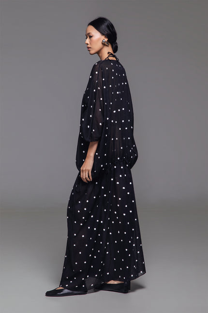 Model wearing Olivine Kaftan in lightweight cotton with relaxed silhouette, adjustable front drawstrings, square neckline, and timeless polka dot print.