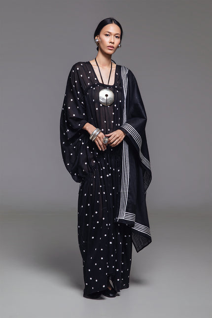 Model wearing Olivine Kaftan in lightweight cotton with relaxed silhouette, adjustable front drawstrings, square neckline, and timeless polka dot print.