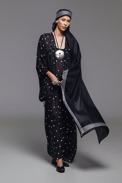Model wearing Olivine Kaftan in lightweight cotton with relaxed silhouette, adjustable front drawstrings, square neckline, and timeless polka dot print.