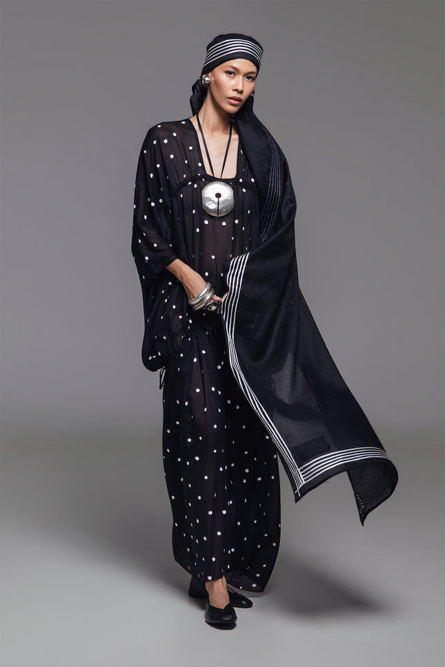 Model wearing Olivine Kaftan in lightweight cotton with relaxed silhouette, adjustable front drawstrings, square neckline, and timeless polka dot print.