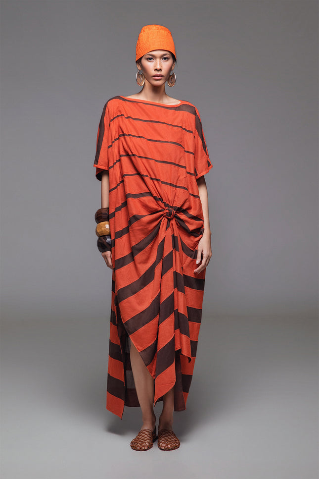 Model wearing Olla Kaftan in lightweight cotton, featuring a rectangular silhouette with contrast stripe appliqué and side slits.