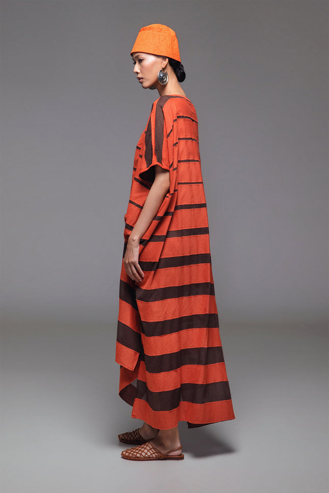 Model wearing Olla Kaftan in lightweight cotton, featuring a rectangular silhouette with contrast stripe appliqué and side slits.