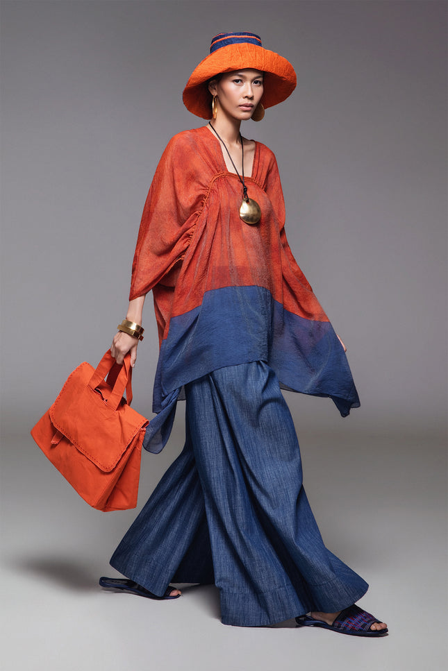 Model wearing BIASA Orrel Tunic with a relaxed voluminous silhouette, square neckline, adjustable drawstrings, and two-tone cotton design.