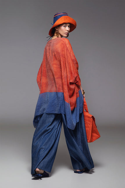 Model wearing BIASA Orrel Tunic with a relaxed voluminous silhouette, square neckline, adjustable drawstrings, and two-tone cotton design.