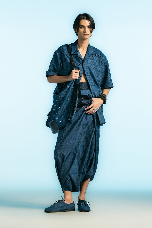 Model wearing the Noctis Oversized Camp Shirt with a relaxed loose silhouette, detailed with all-over tiger-skin embroidery, styled with matching-toned trousers for a modern, cohesive look.