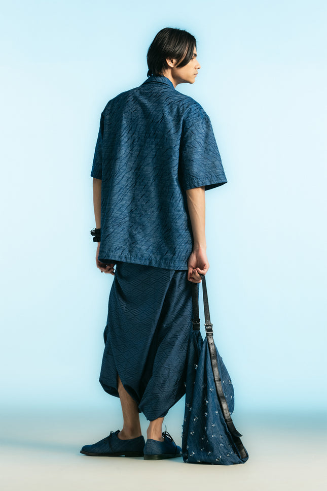 Model wearing the Noctis Oversized Camp Shirt with a relaxed loose silhouette, detailed with all-over tiger-skin embroidery, styled with matching-toned trousers for a modern, cohesive look.