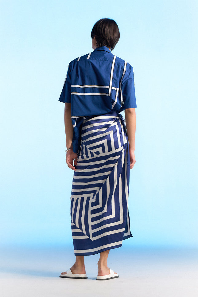 Model wearing Noga Camp Shirt in lightweight cotton, featuring reflected stripe applique, a regular-fit silhouette, and a seamless patch pocket.