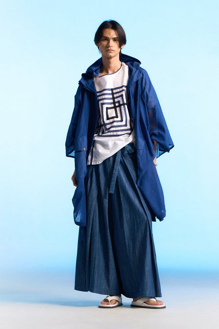 Model wearing the Nayeli Poncho with an oversized, hooded silhouette, featuring a hidden button opening and adjustable drawstring details that create a soft, flowing shape for modern everyday layering.