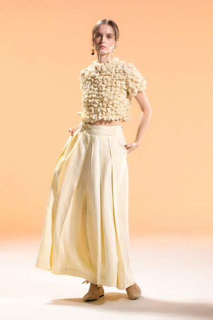 Model wearing Nailah Top in pure cotton, featuring a cropped silhouette with sculpted textured surface and three-dimensional design.