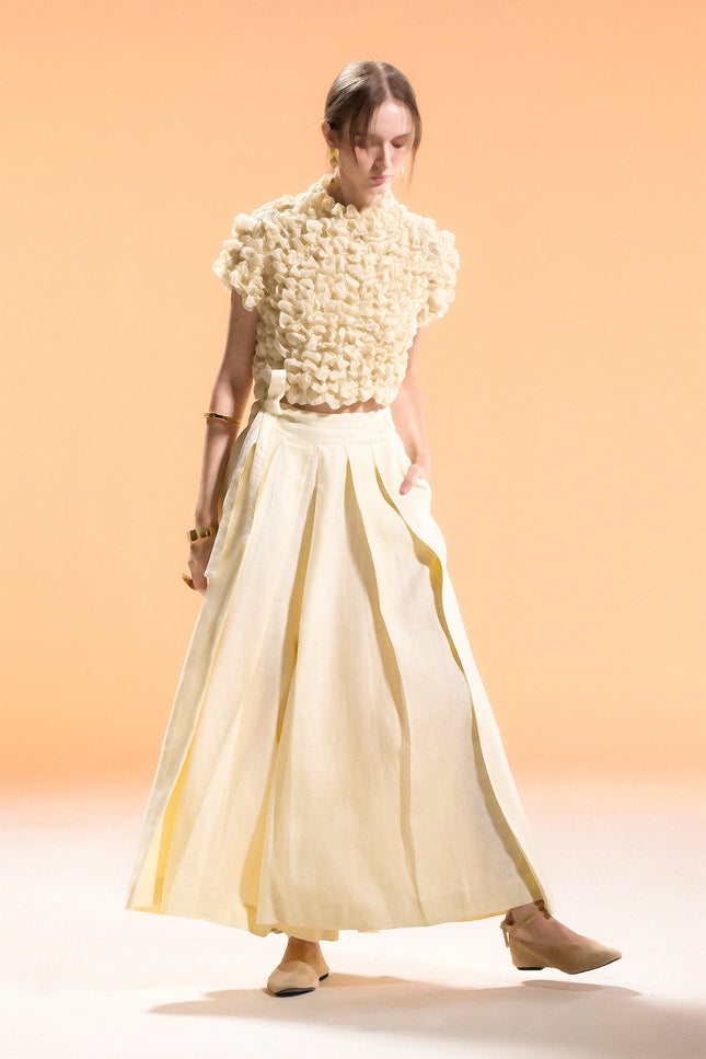 Model wearing Nailah Top in pure cotton, featuring a cropped silhouette with sculpted textured surface and three-dimensional design.